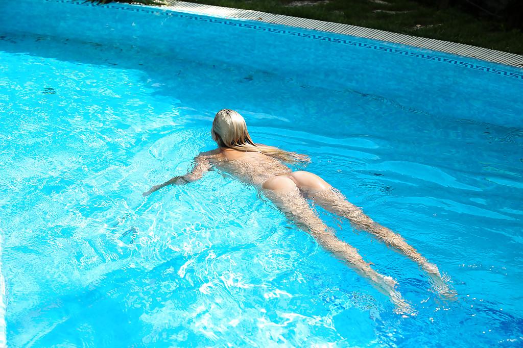 16P Leggy blonde Christen is sitting at the poolside and playing with puss