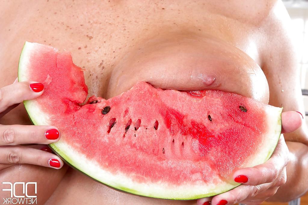 16P European MILF Sheila Grant wetting hooters with melon juice in kitchen