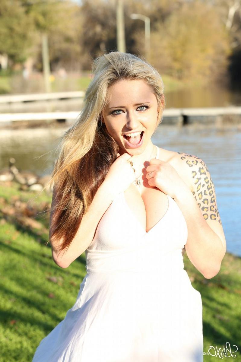 15P Lily Xo poses and shows her pink panties on the rocks