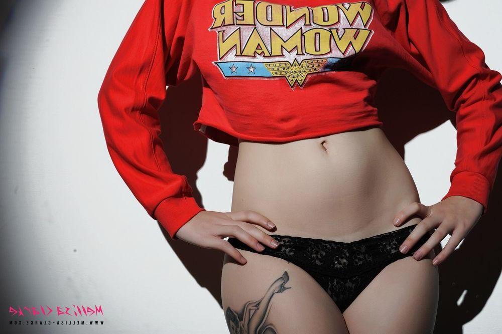 12P Pictures of teen model Melissa Clarke exposing her perky breasts