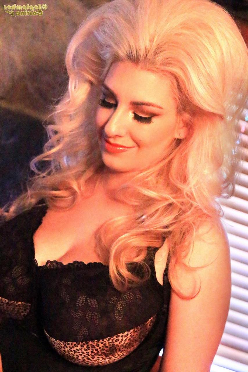 15P Busty blonde September Carrino flashes her big boobs in a corset