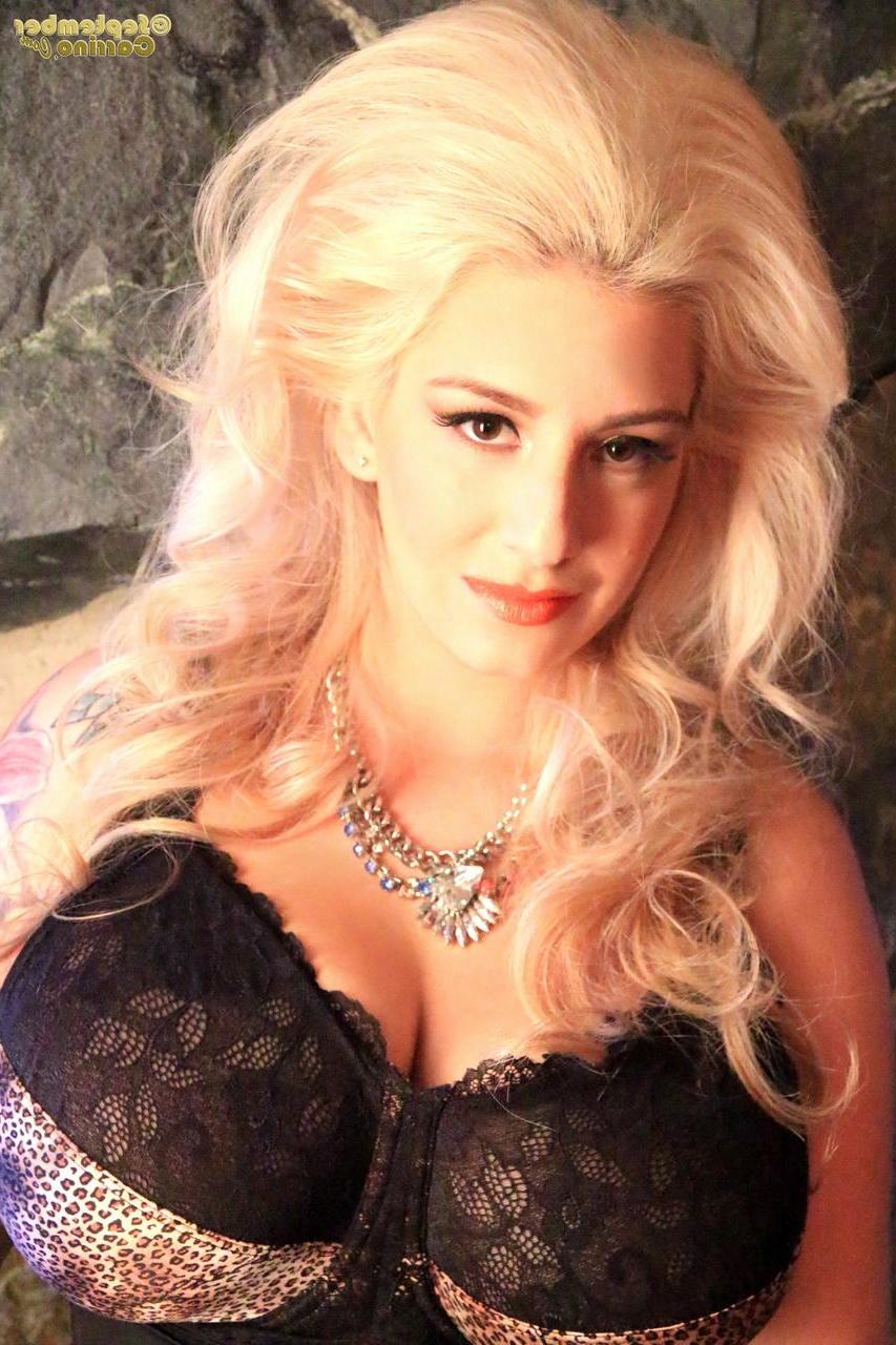 15P Busty blonde September Carrino flashes her big boobs in a corset