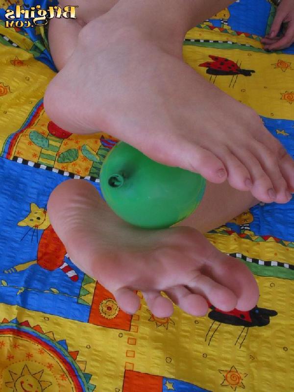 15P Cute brunette teen uses her feet to play with a balloon