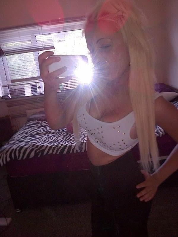 10P Chick flaunts her big round tits while posing in tight tops
