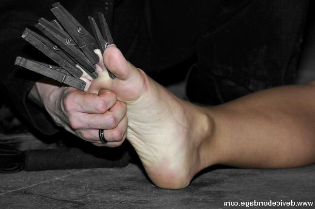15P Two girls bound in straps and in a small metal cage