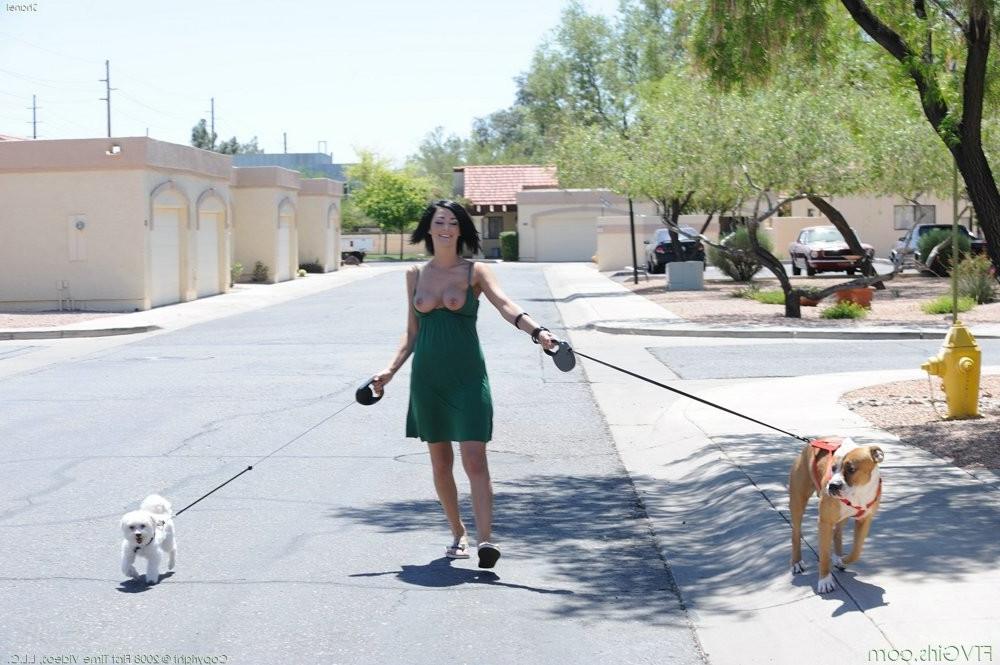 15P An amateur girl walks with her two huge dogs outdoor
