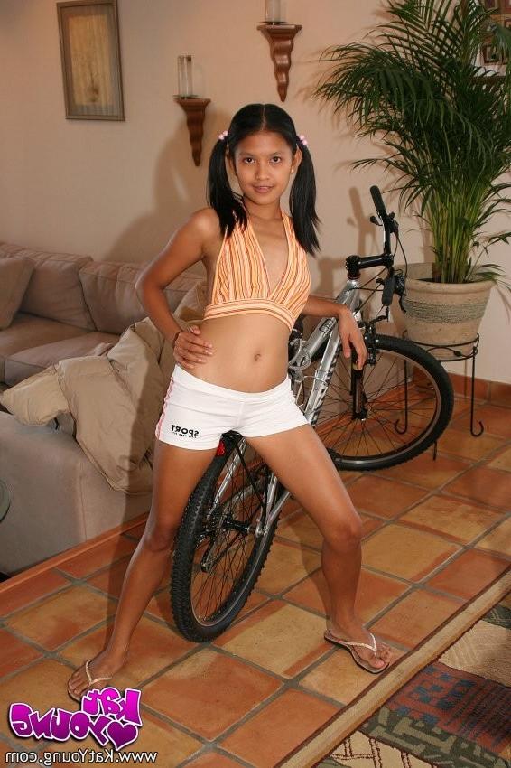 12P Exotic Kat peels her clothes off to reveal her smooth tanned body