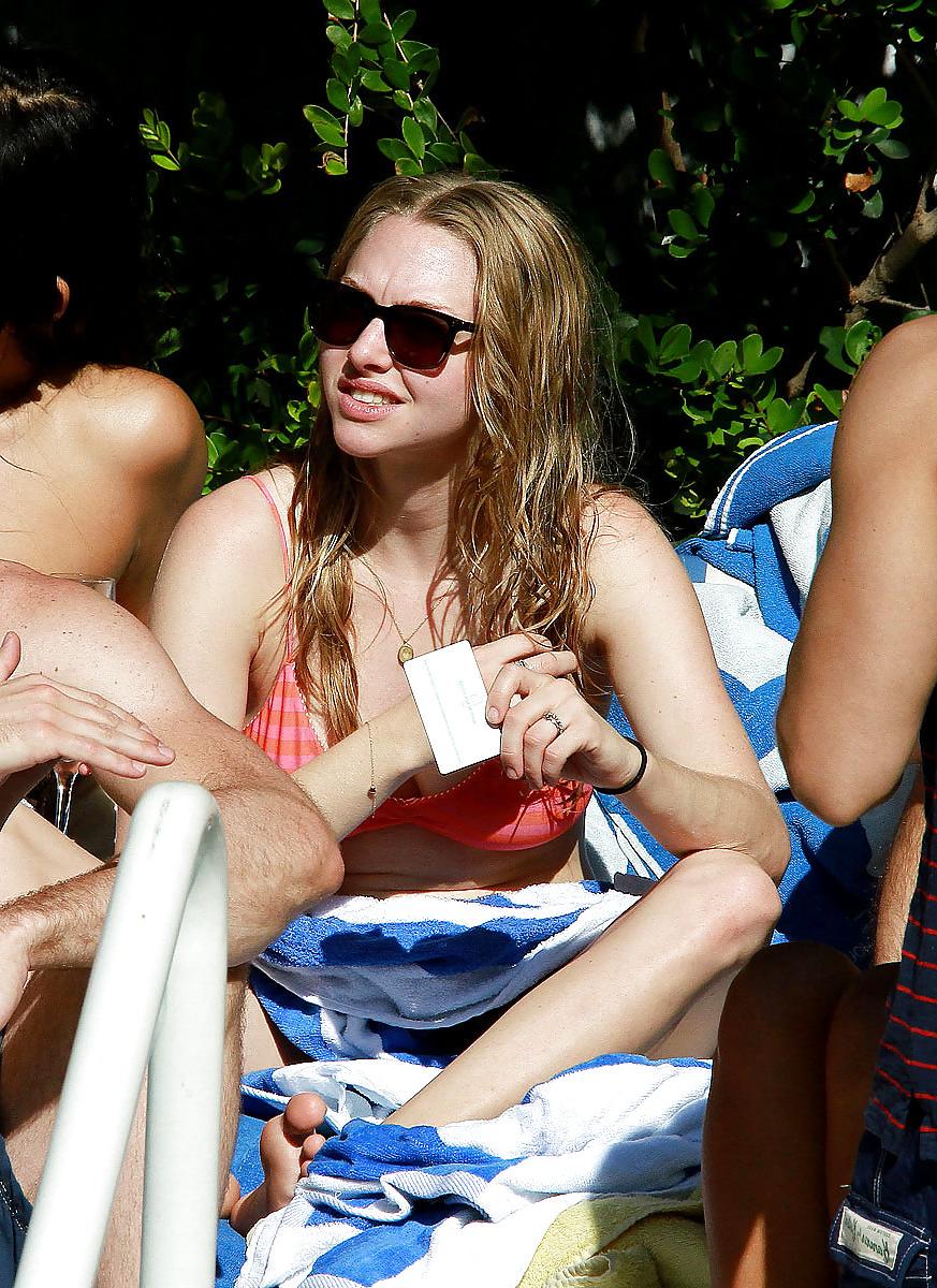 6P Amanda Seyfried wearing a bikini top at a pool in Miami