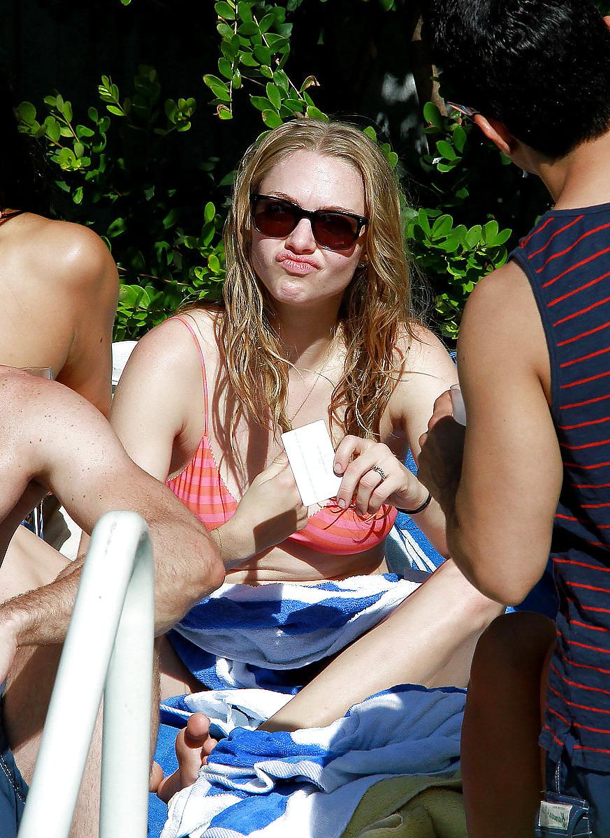 6P Amanda Seyfried wearing a bikini top at a pool in Miami