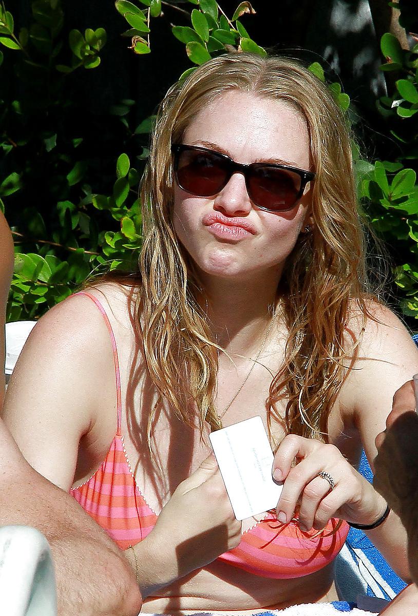 6P Amanda Seyfried wearing a bikini top at a pool in Miami