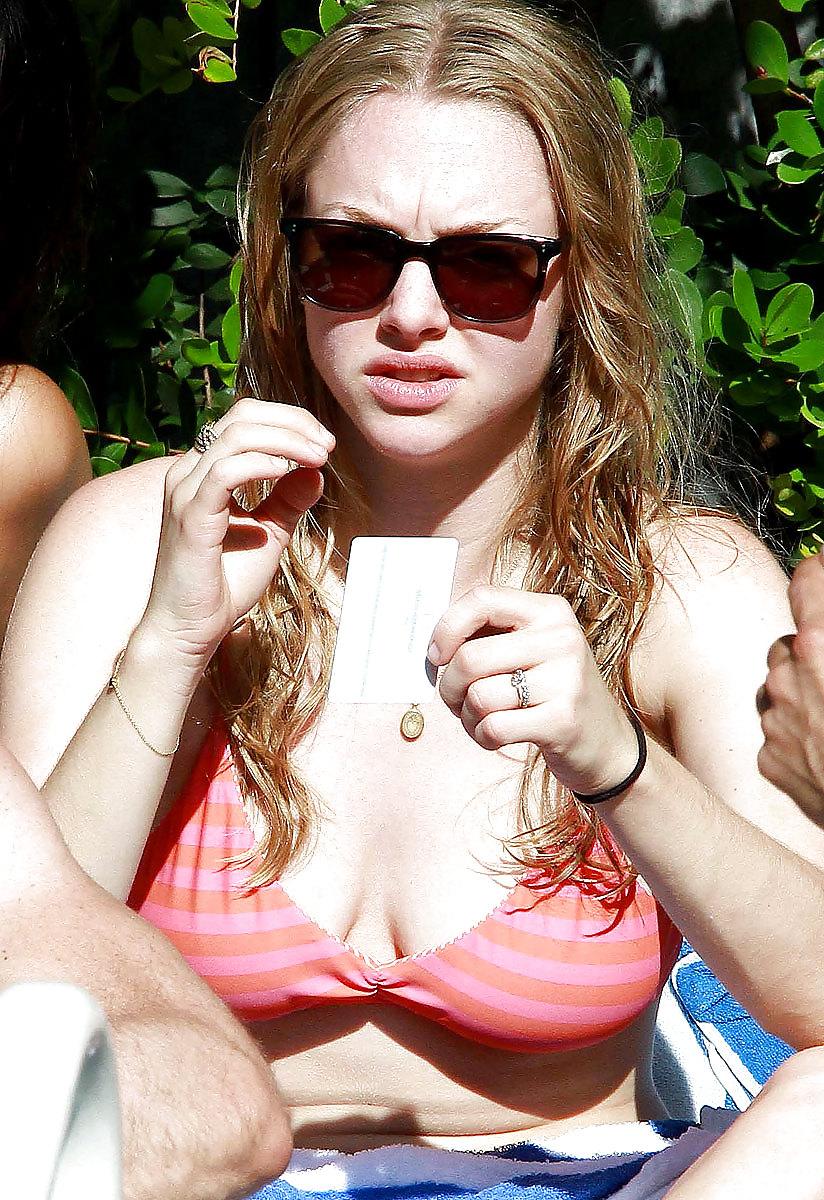 6P Amanda Seyfried wearing a bikini top at a pool in Miami