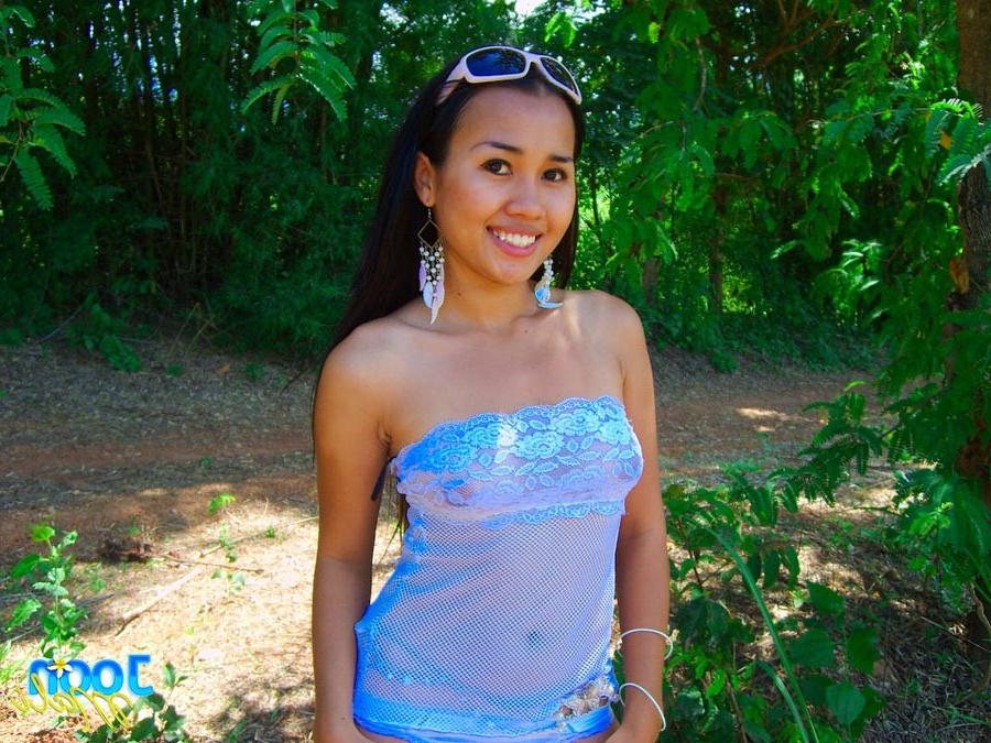 16P Thai girl in sunglasses outside