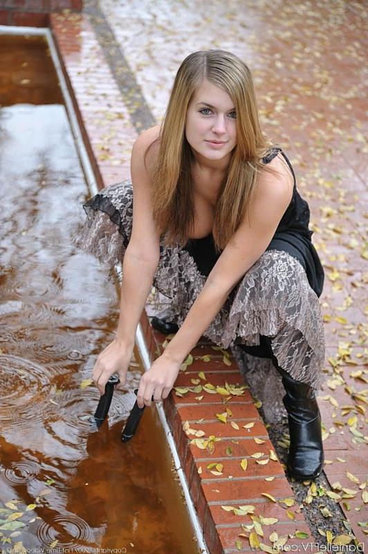 15P Busty girl in glasses walks naked in public courtyard