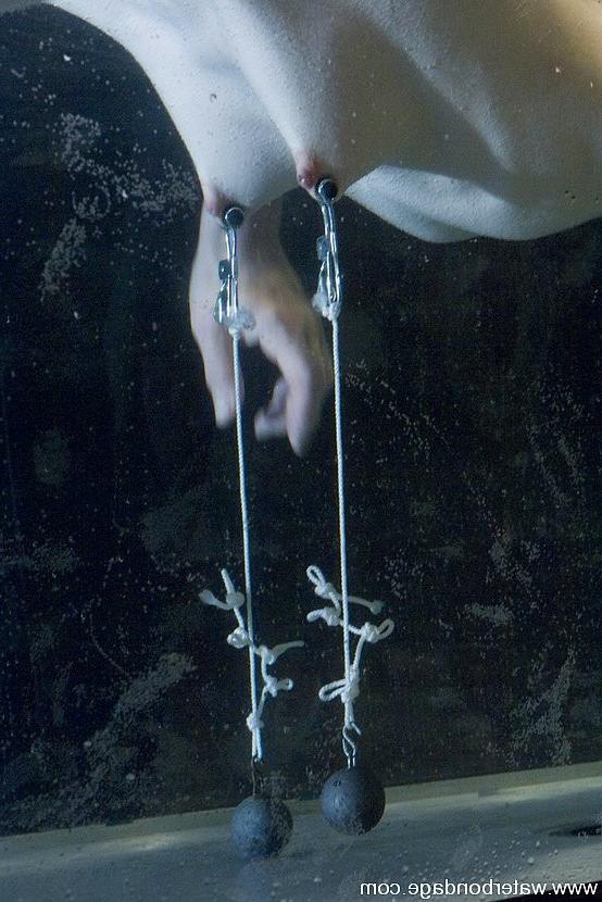 15P Isobel Wren is bound in big water tank getting nipples stretched