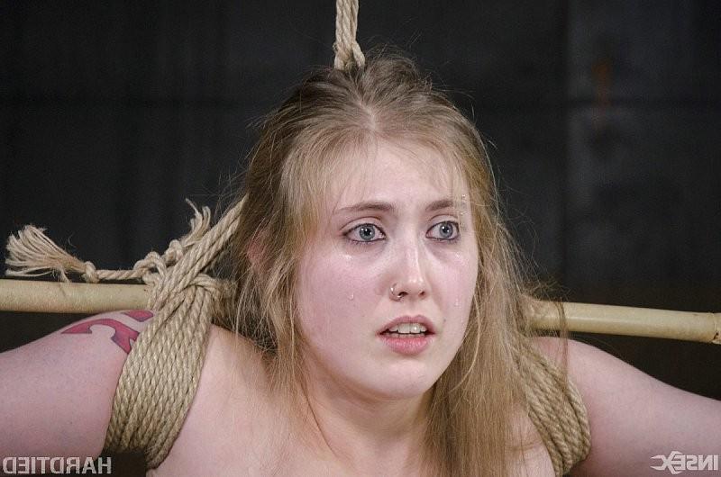 15P Electra Rayne busty long hair blonde is cross bound in rope