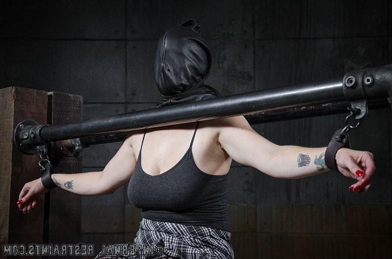 14P Bella Rossi pantyhose redhead is bound between metal pipes in du