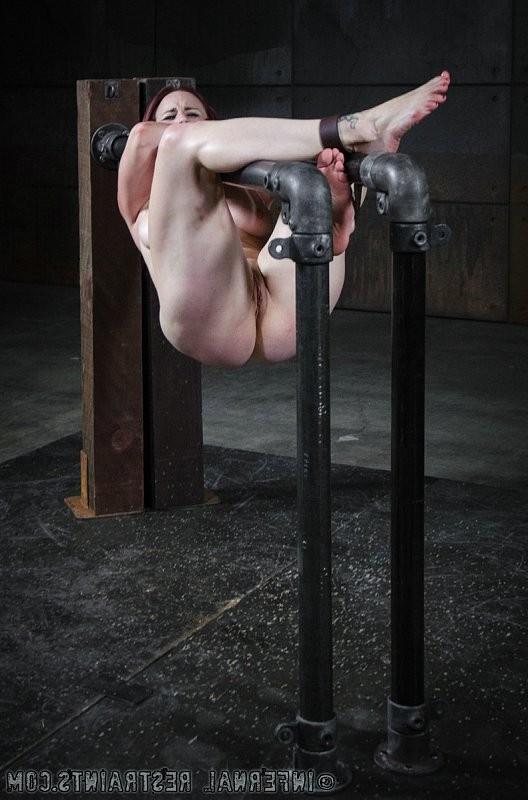 14P Bella Rossi pantyhose redhead is bound between metal pipes in du