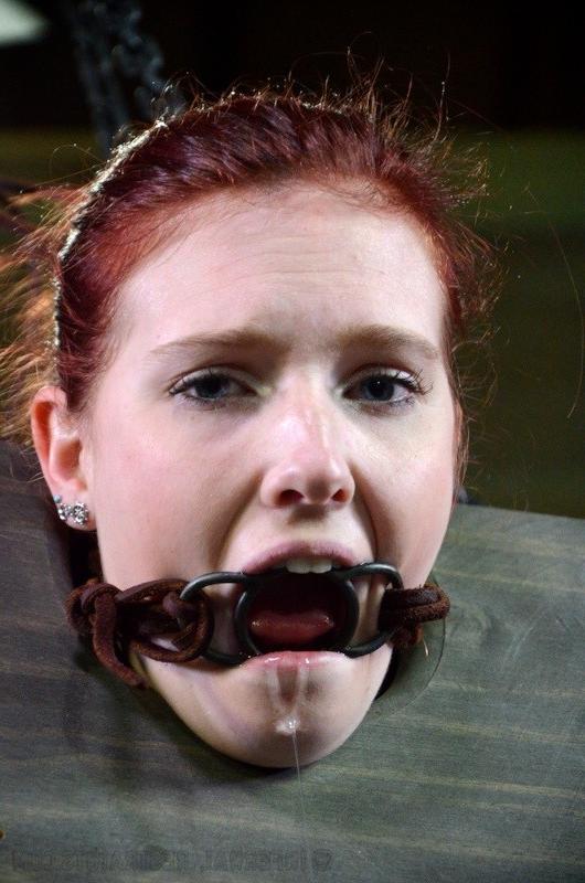 16P Ashley Lane redhead bound in dungeon with leather and dribbling