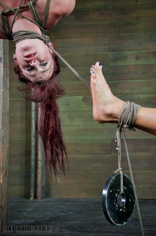 16P Nikki Darling and Bella Rossi bound together in a dark dungeon
