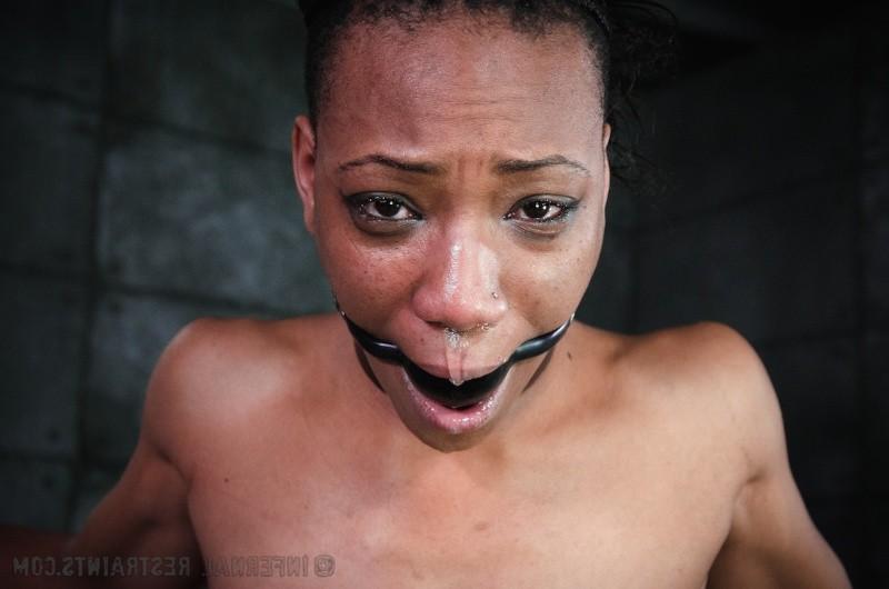 16P Nikki Darling ebony is bound in wooden stocks her feet spanked