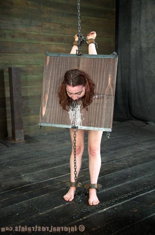 16P Maggie Mead bound in wooden stock her shaved pussy vibrated