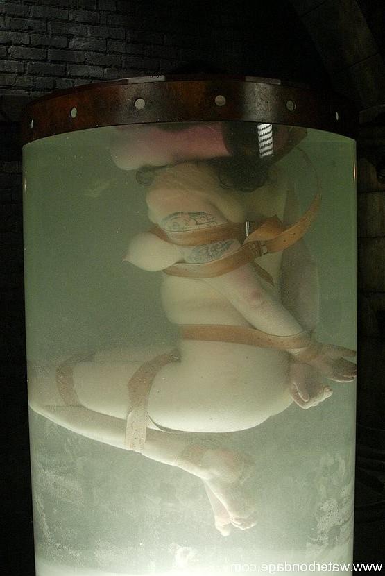 15P Stacy Stax busty babe is bound in rope and dunked in water tank