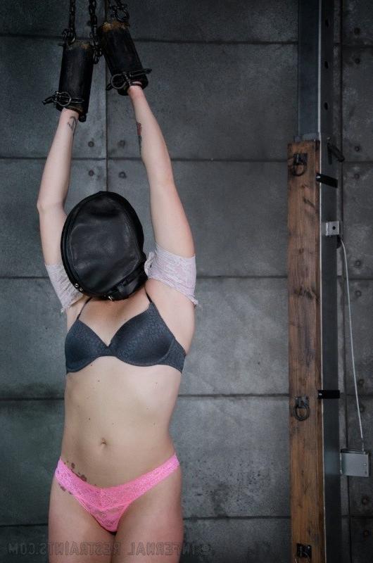16P Josi Valentine is bound with her hands in spread in a dark dungeon