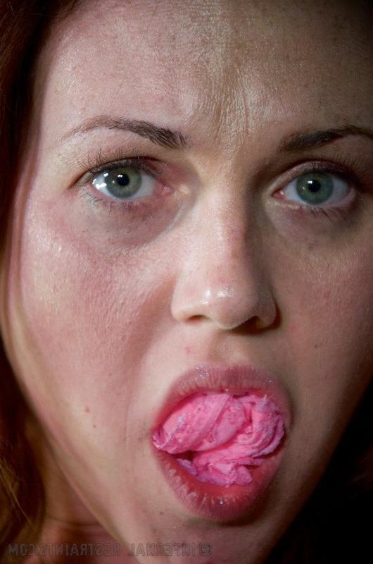16P Josi Valentine is bound with her hands in spread in a dark dungeon