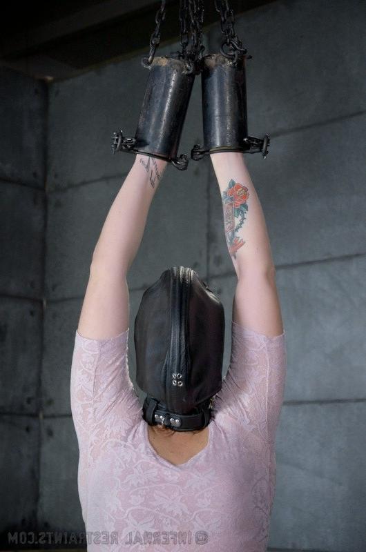 16P Josi Valentine is bound with her hands in spread in a dark dungeon