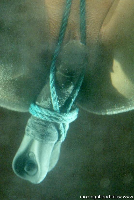 15P Isis Love blonde is rope bound in watertank and put on ice