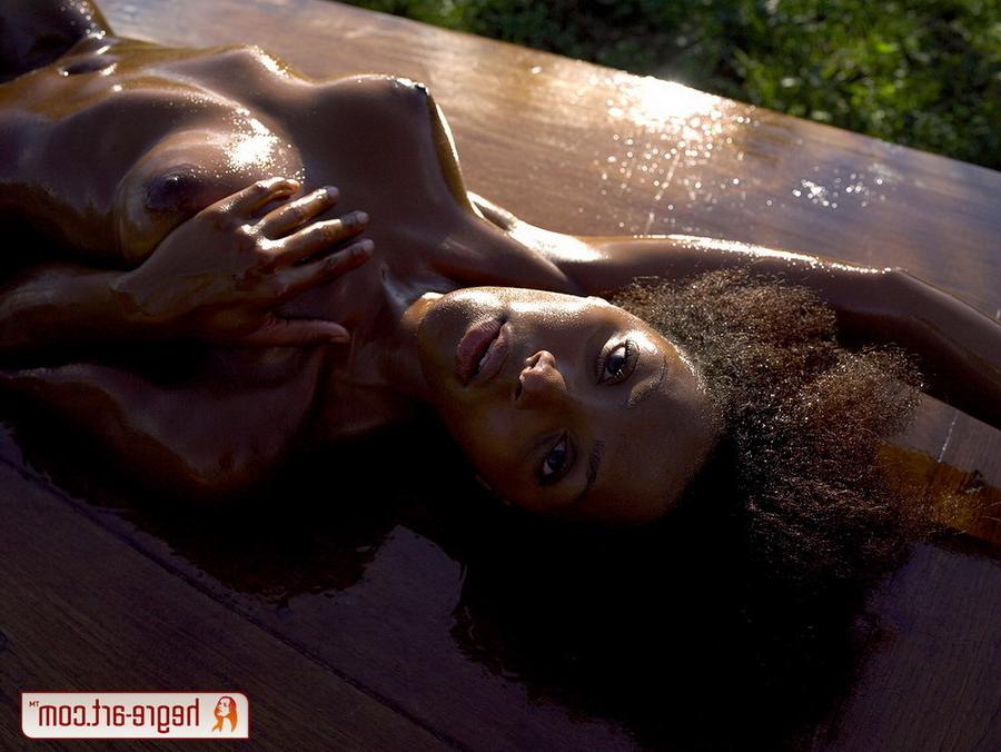16P Ebony girl in olive oil on a table