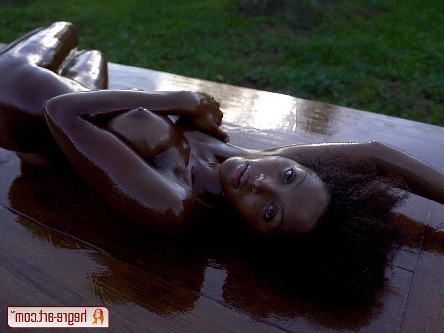 16P Ebony girl in olive oil on a table