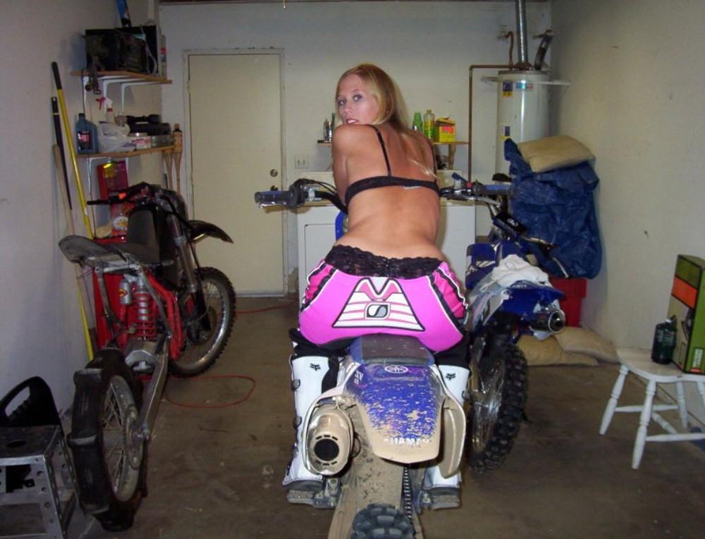 15P A blonde chicks riding a bike strips and shows her pink pussy