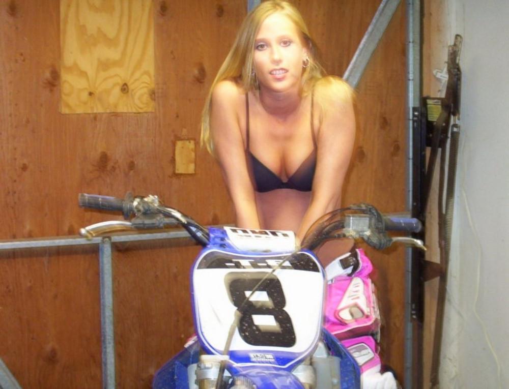15P A blonde chicks riding a bike strips and shows her pink pussy