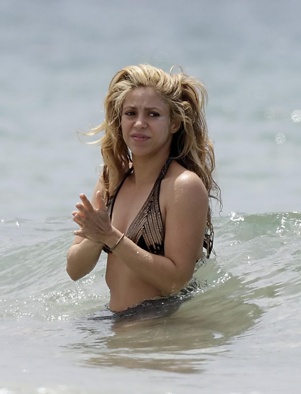 16P Shakira in a skimpy thong bikini at the beach