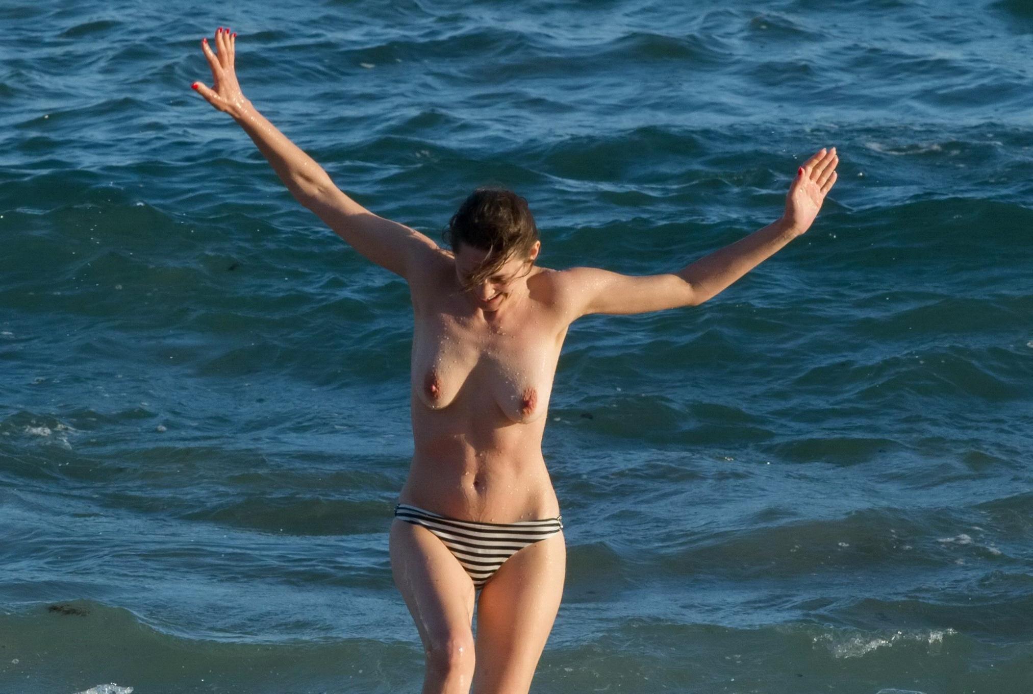 16P Marion Cotillard swimming topless at the beach
