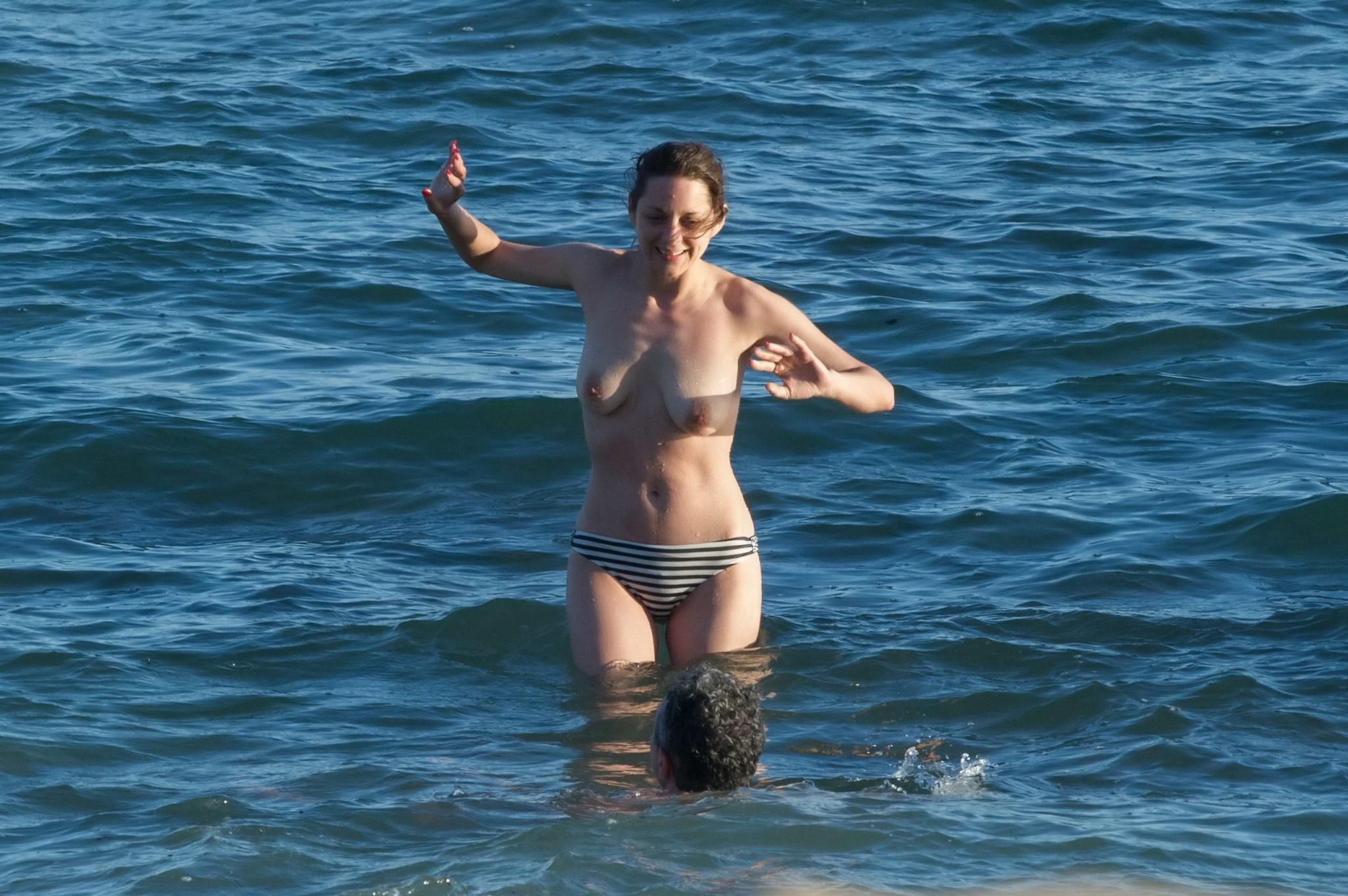 16P Marion Cotillard swimming topless at the beach