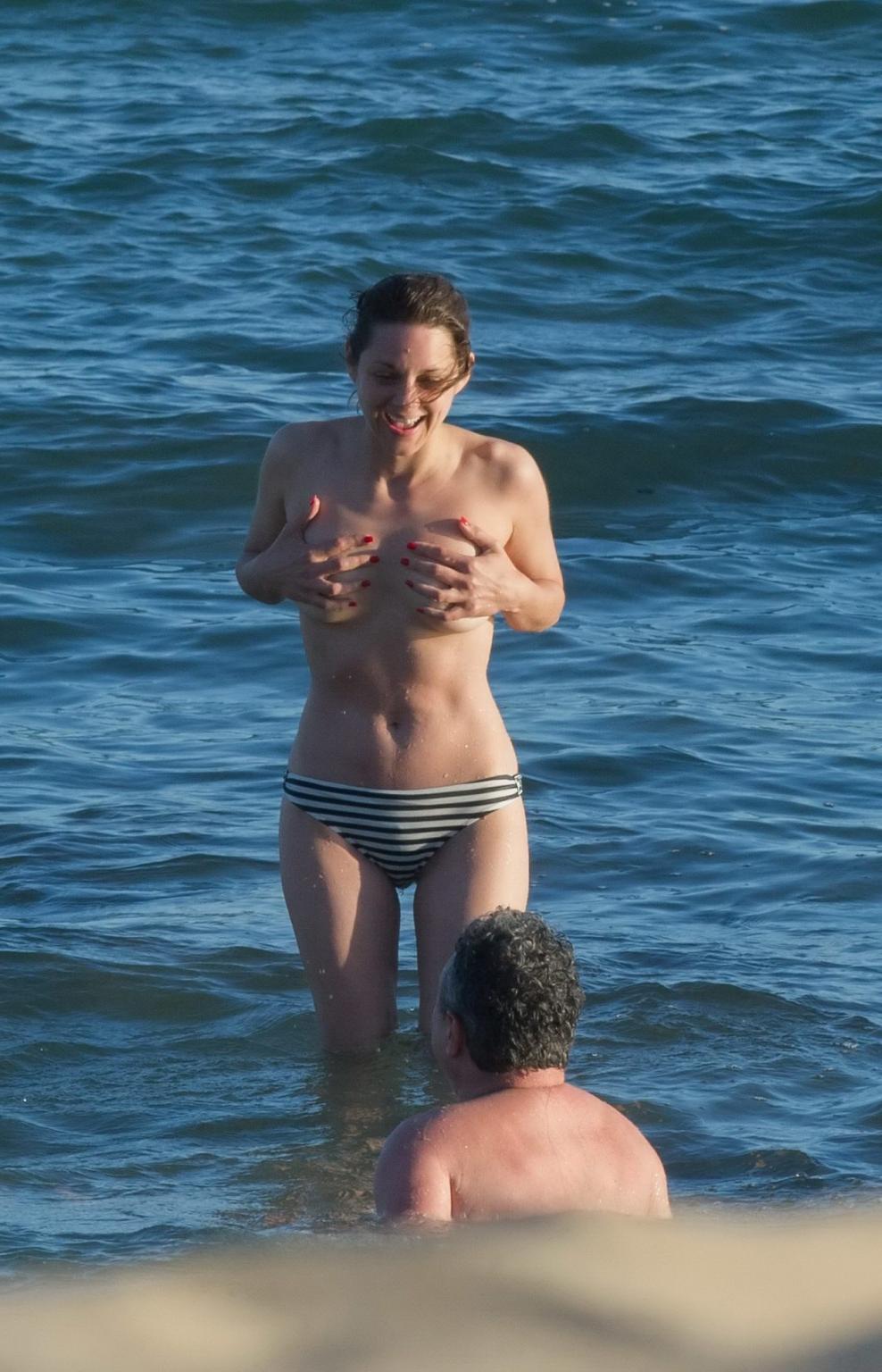 16P Marion Cotillard swimming topless at the beach