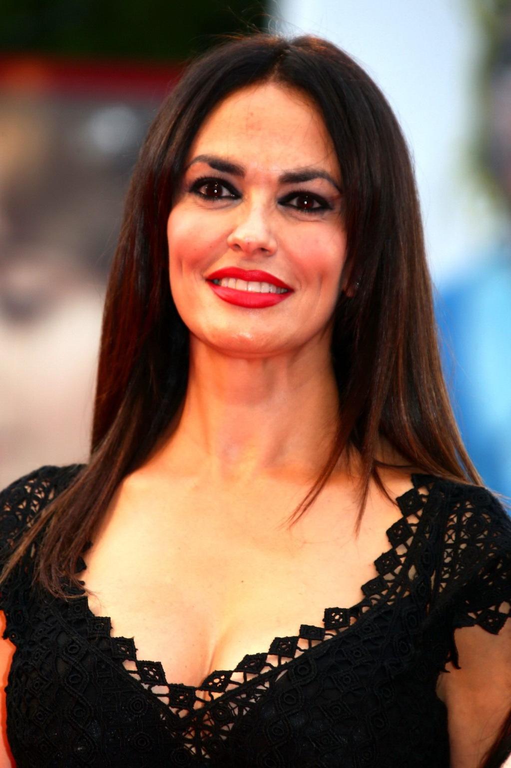 16P Maria Grazia Cucinotta busty wearing a low cut dress