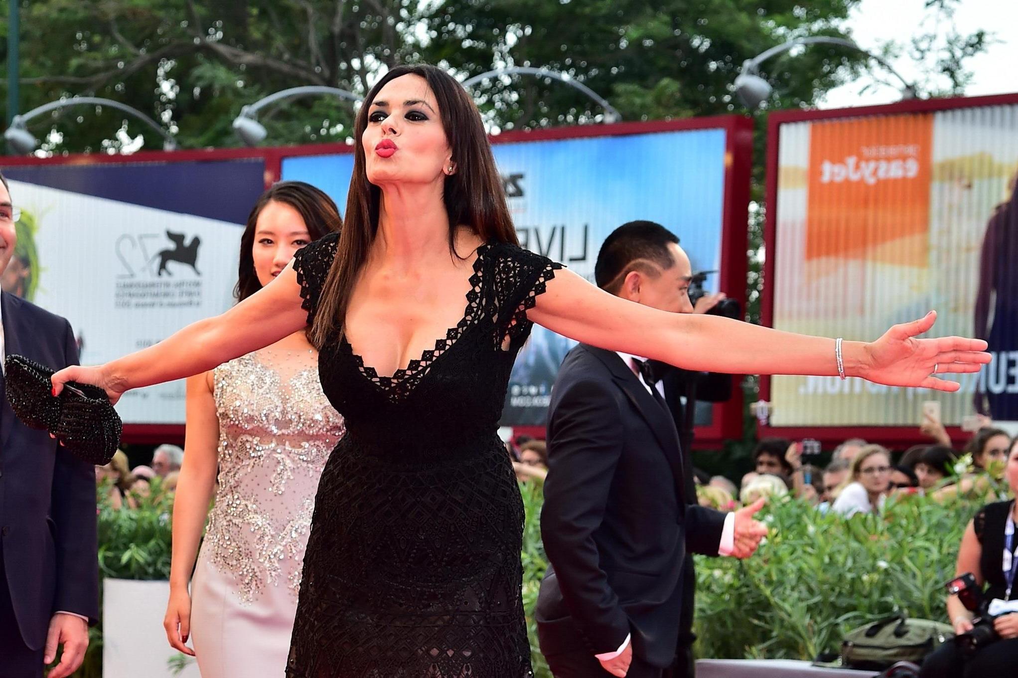 16P Maria Grazia Cucinotta busty wearing a low cut dress