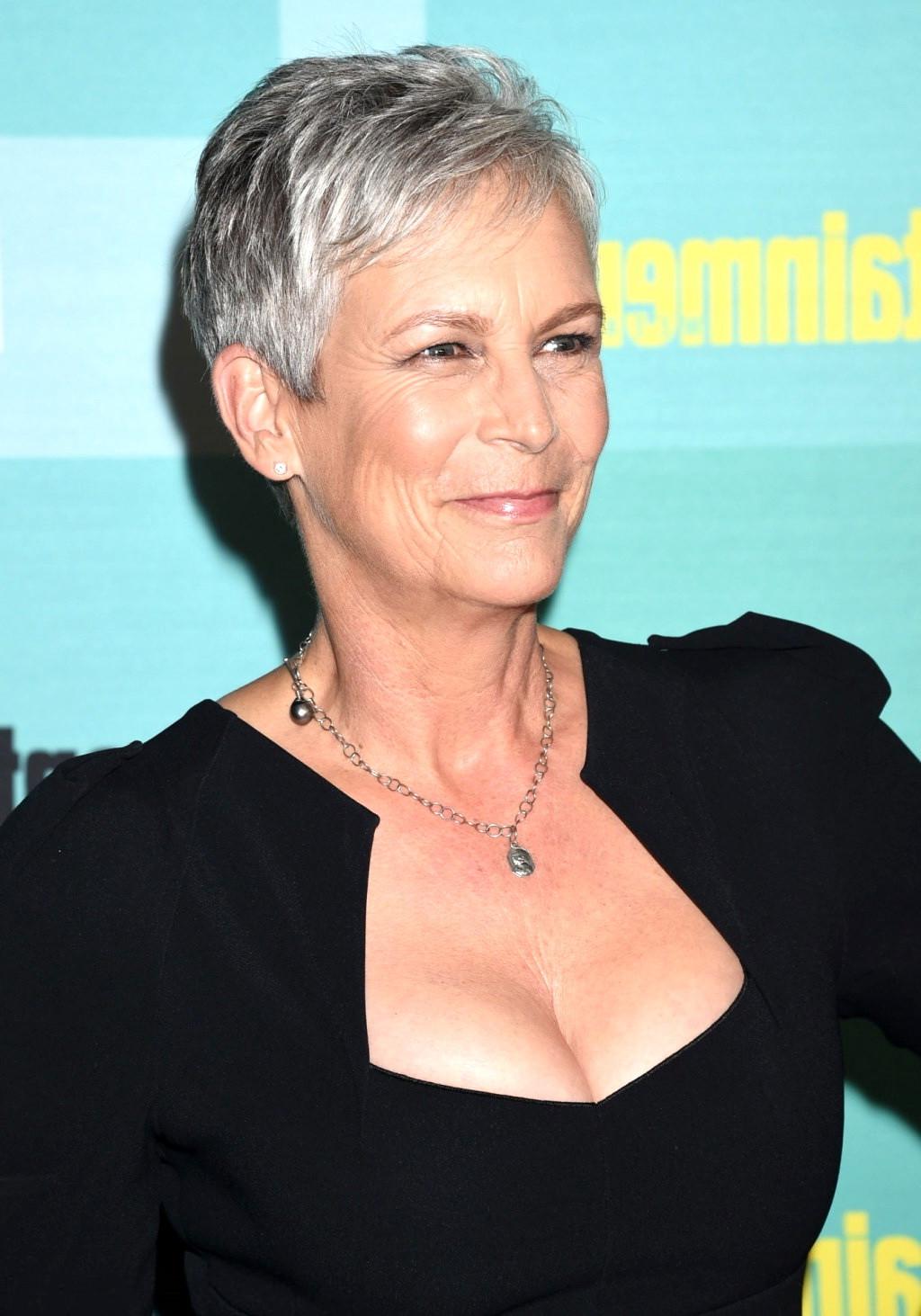 16P Jamie Lee Curtis shows cleavage wearing a low cut dress