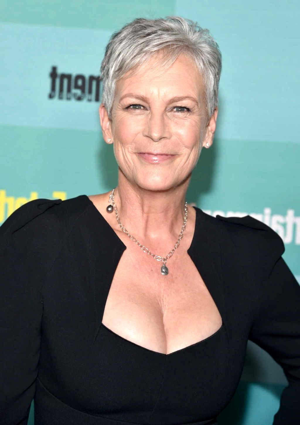 16P Jamie Lee Curtis shows cleavage wearing a low cut dress