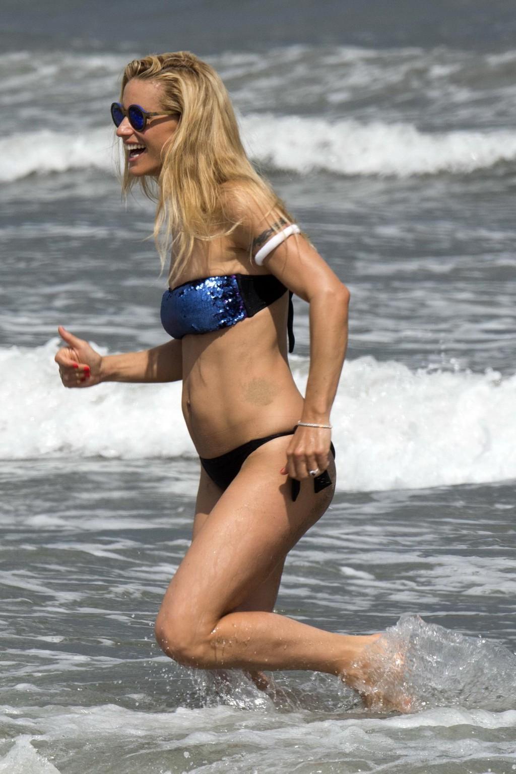 16P Michelle Hunziker wearing a tube bikini on an Italian beach