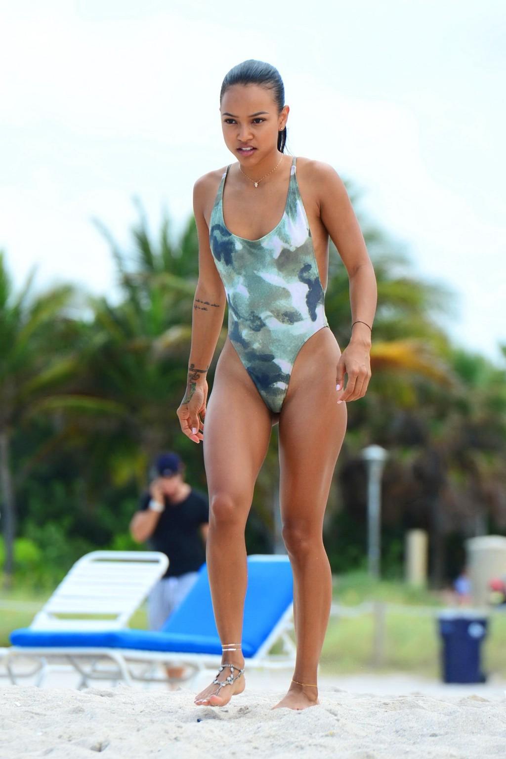 16P Karrueche Tran shows sideboob and ass in tiny camo swimsuit at the beach