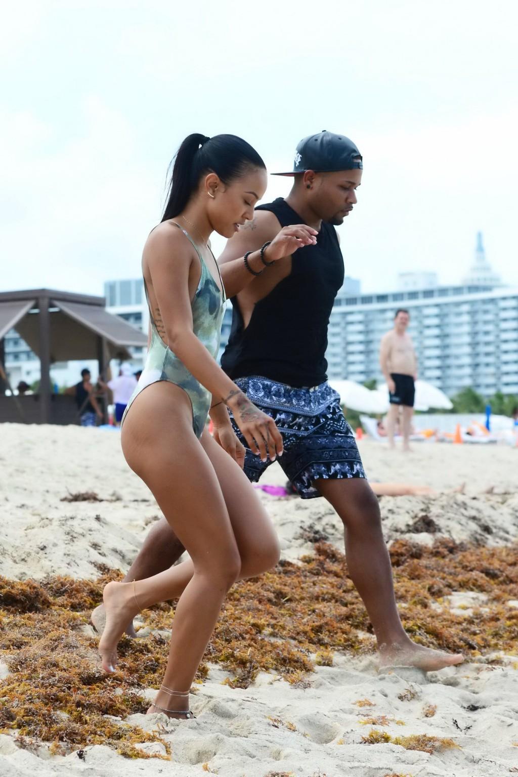 16P Karrueche Tran shows sideboob and ass in tiny camo swimsuit at the beach