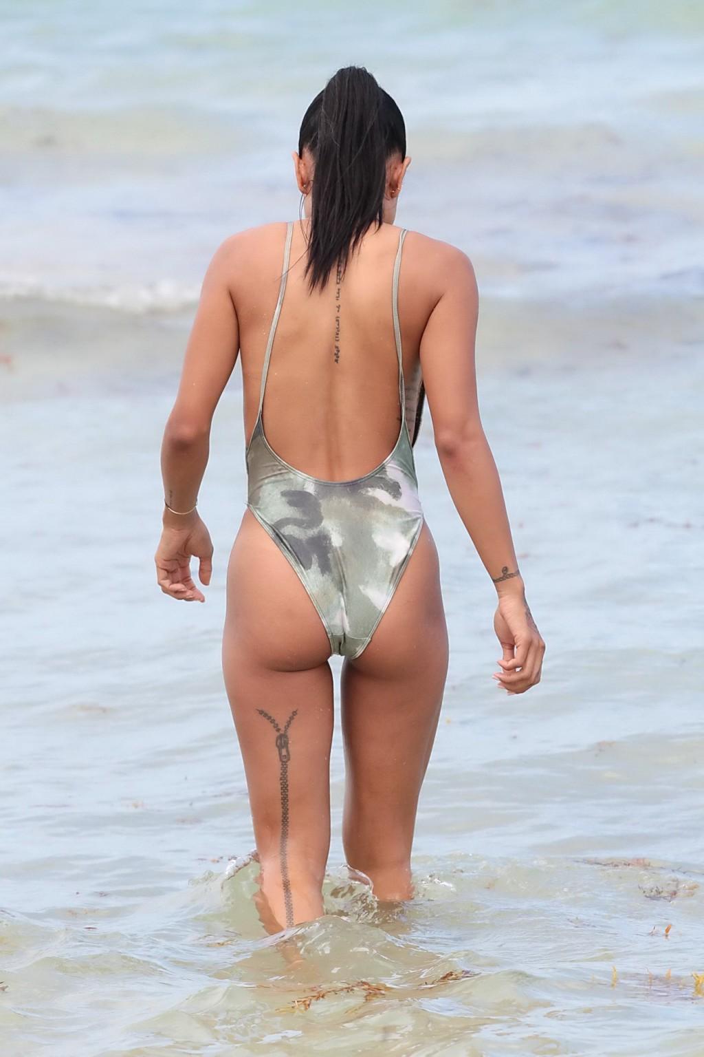 16P Karrueche Tran shows sideboob and ass in tiny camo swimsuit at the beach