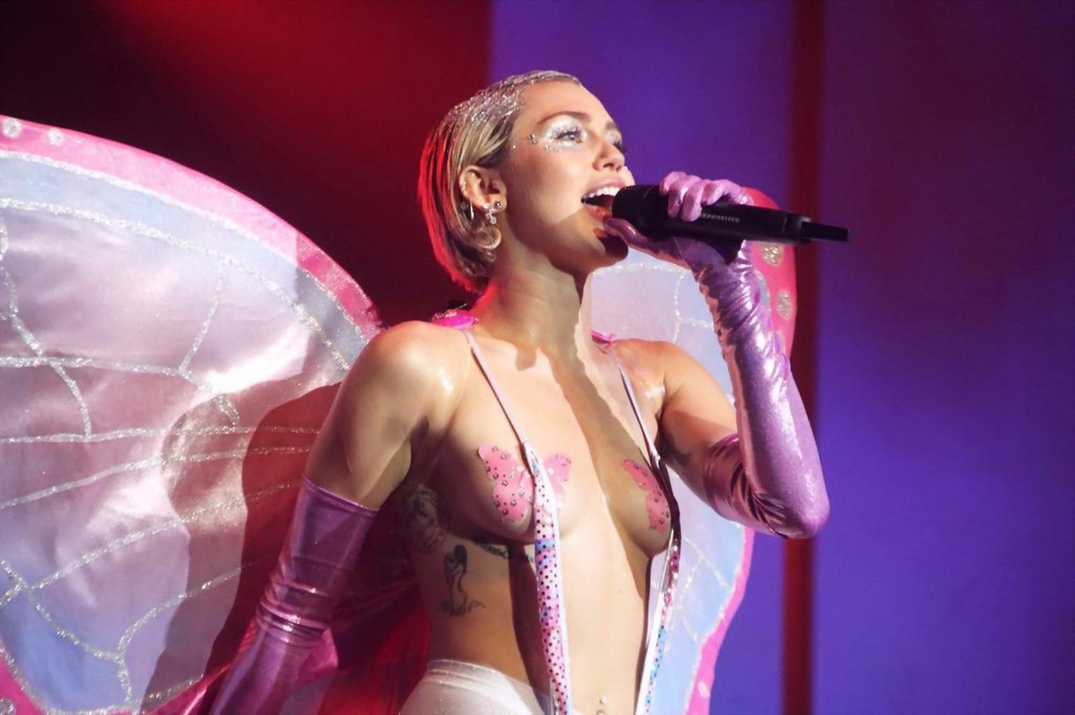 16P Miley Cyrus topless wearing butterfly pasties and pantyhose while performing at 