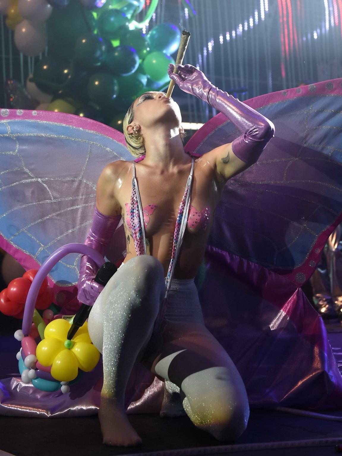 16P Miley Cyrus topless wearing butterfly pasties and pantyhose while performing at 