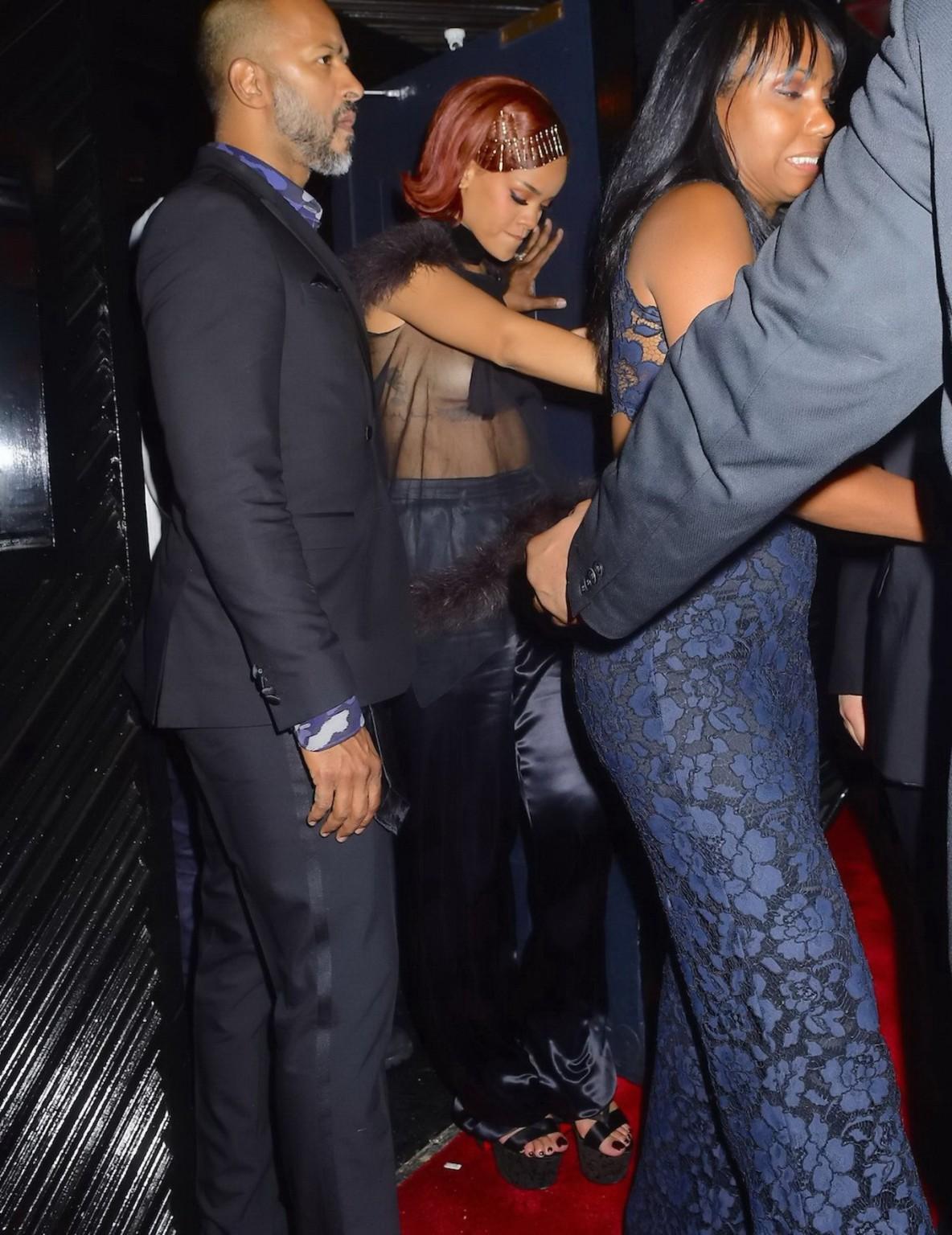 16P Rihanna showing off her boobs braless in a see through top at Met Gala After Par