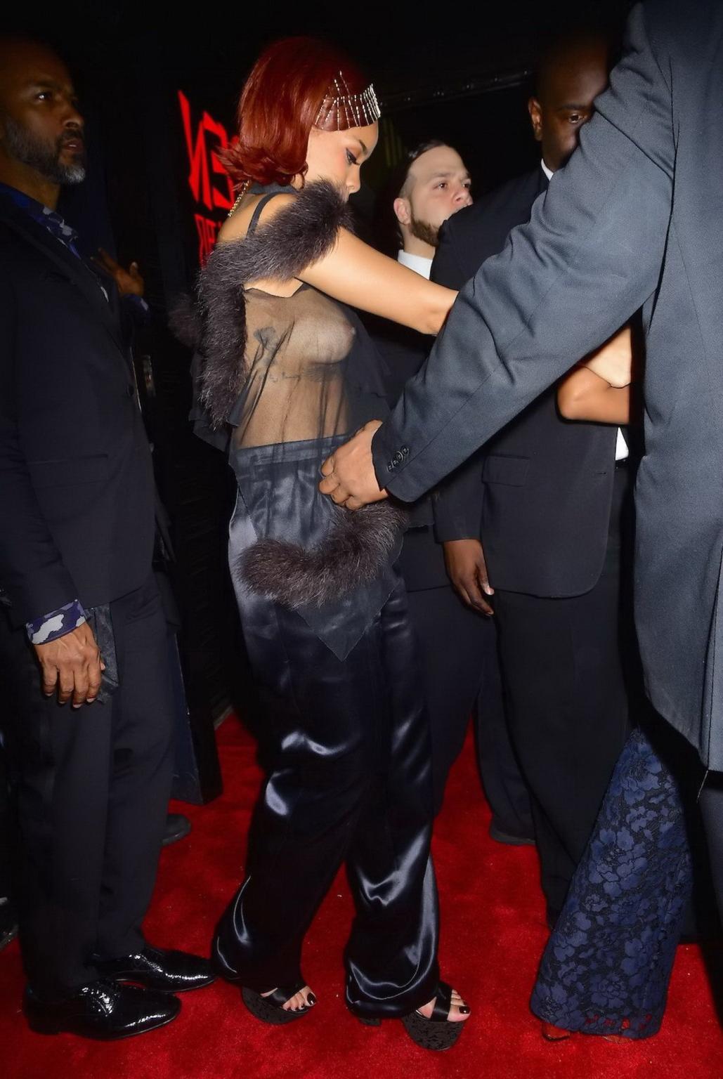 16P Rihanna showing off her boobs braless in a see through top at Met Gala After Par